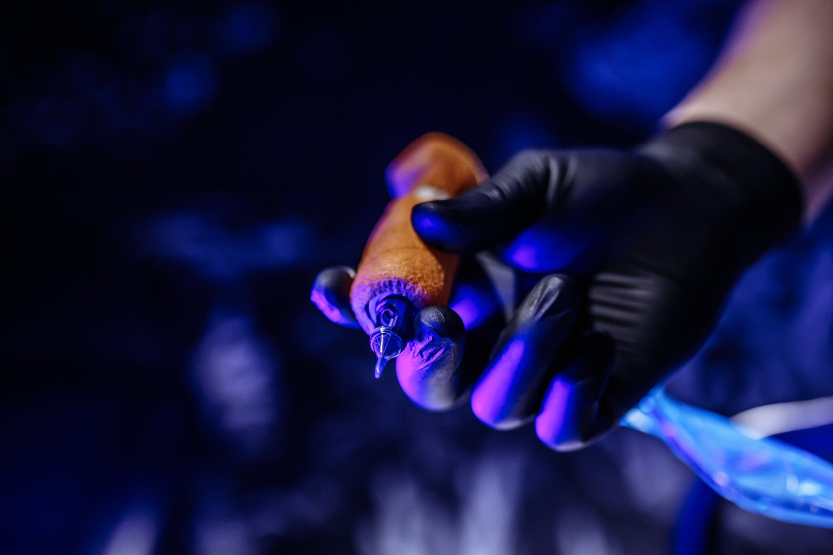 Tattoo Machine in the Hands of a Tattoo Artist